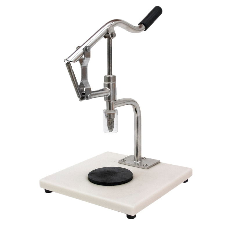 1BBB9S-EZshucker is a machine which opens oysters by hand. The image shows an Stainless steel ezshucker surrounded by oysters while on a chefstone granite tray